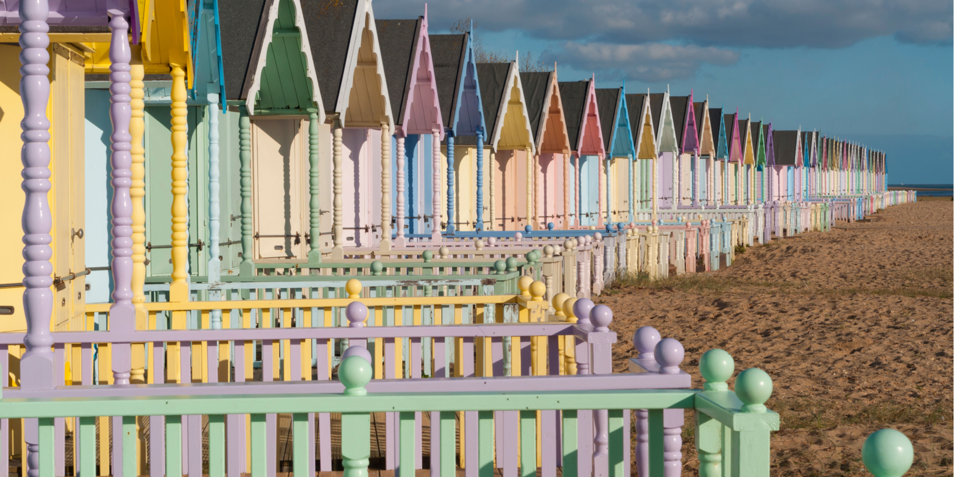 Brightly coloured beach huts at Mersea, Essex