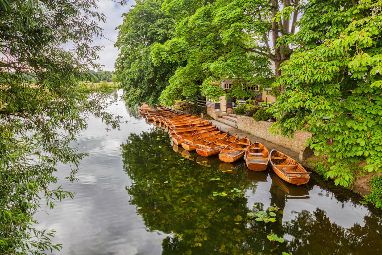 Wooden rowing boats on the River Stour at Dedham, Essex